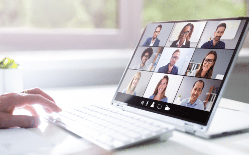 A small business owner hosting a virtual meeting for his out-of-state employees