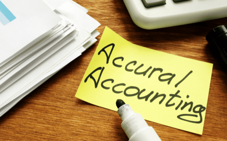 Accounting paperwork sticky note that says accrual accounting