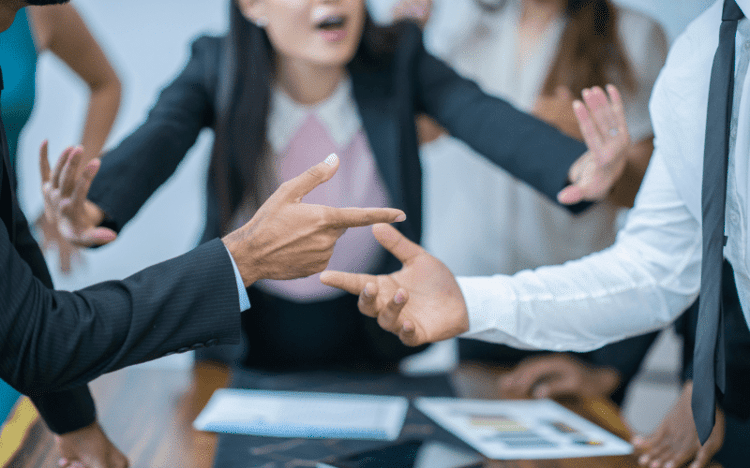 Small business owners and accountant arguing at a table