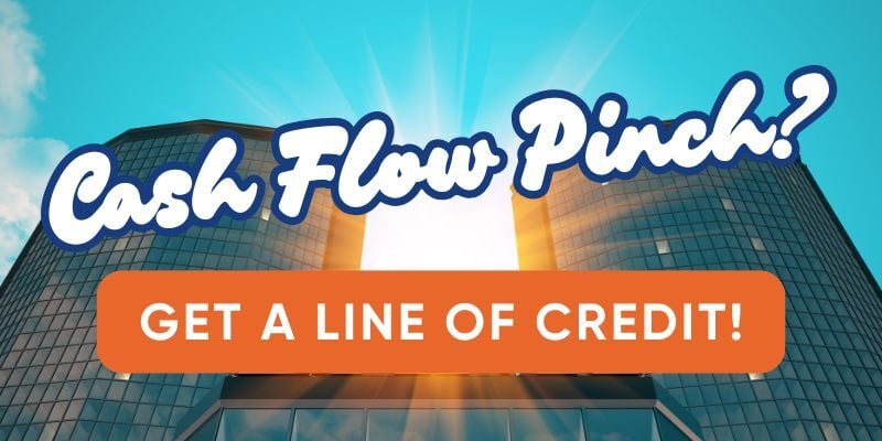 Bank building with text: Cash flow pinch? Get a line of credit!