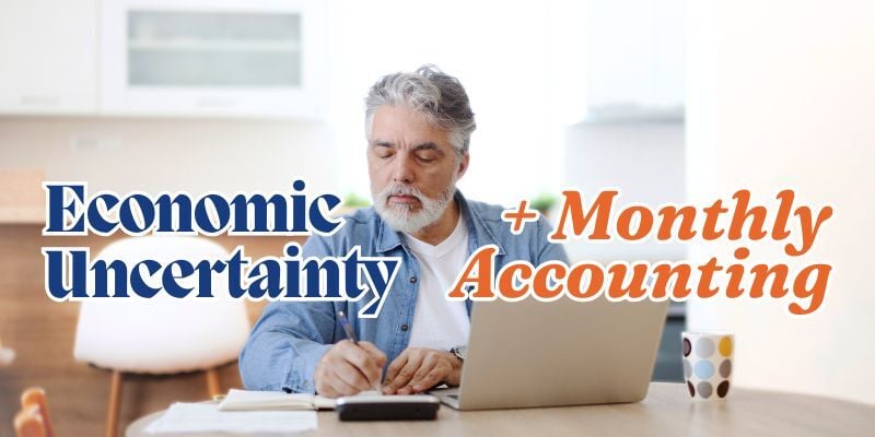 man using laptop and calculator with text: Economic uncertainty + monthly accounting